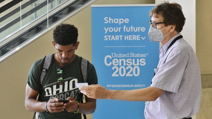 Census worker Don Nunnelley, right, helps Omar Contaro Raimundo with information to access the 2020 Census website to be counted Monday, August 31, 2020 at the Butler County Government Services Center in Hamilton. NICK GRAHAM / STAFF