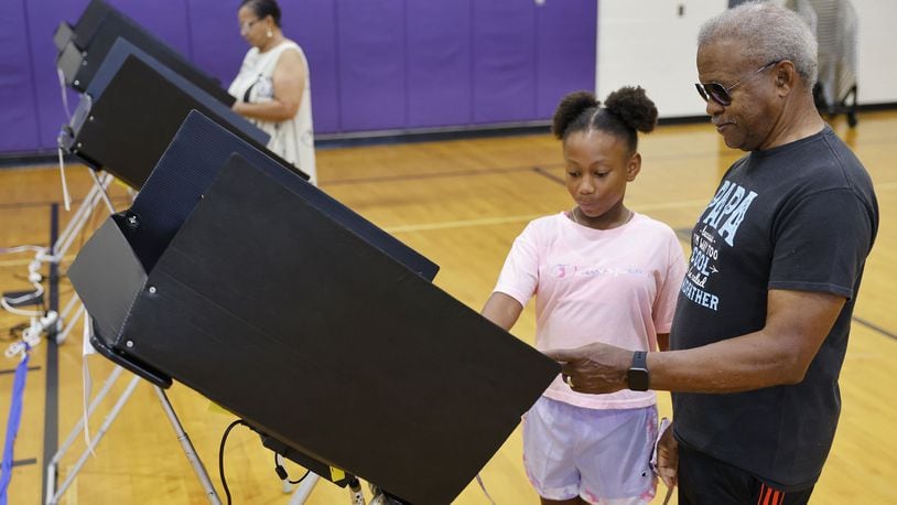 Harry and Lois Truss brought their great granddaughter, Maddisyn Davis, 10, with them to teach her about voting with Issue 1 on the ballot Tuesday, Aug. 8, 2023 at Rosa Parks Elementary School in Middletown. NICK GRAHAM/STAFF