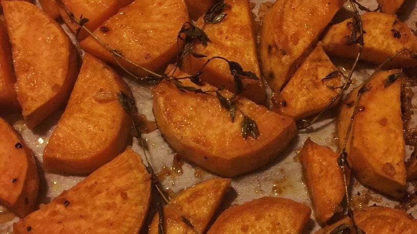 These Garlic ‘N’ Honey Roasted Sweets are a modern twist on traditional candied sweet potatoes. The garlic along with chipotle chile powder provide a delectable balance to the sweetness of the honey and potatoes. CONNIE POST/STAFF