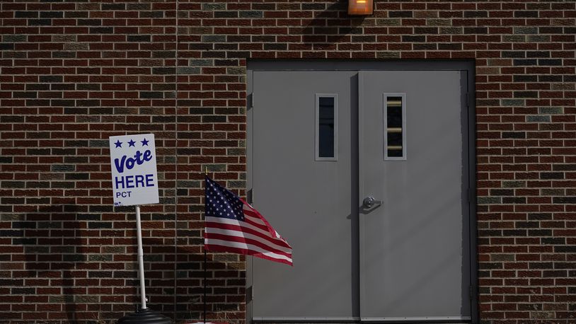 The door of the Jeffersonville Masonic Lodge polling location is marked with an American Flag and a "Vote Here" sign on Election Day in Jeffersonville, Ohio, Tuesday, Nov. 7, 2023. Polls are open in a few states for off-year elections that could give hints of voter sentiment ahead of next year's critical presidential contest. (AP Photo/Carolyn Kaster)