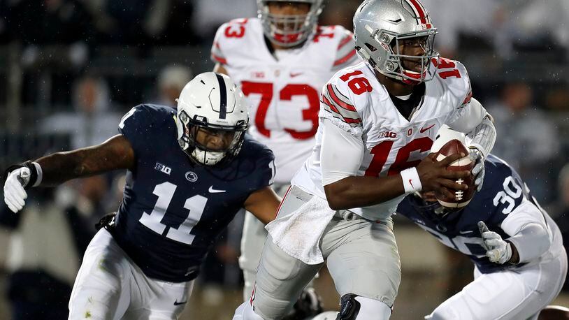 STATE COLLEGE, PA - OCTOBER 22:  J.T. Barrett #16 of the Ohio State Buckeyes is hurried by Brandon Bell #11 of the Penn State Nittany Lions in the first half during the game on October 22, 2016 at Beaver Stadium in State College, Pennsylvania.  (Photo by Justin K. Aller/Getty Images)