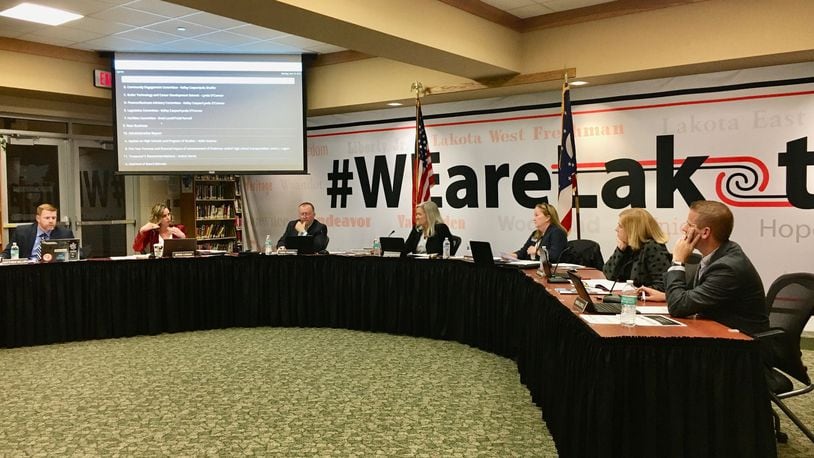 Lakota Schools Treasurer Jenni Logan (second from left) explains to board members Monday evening the projected budget shortfalls coming to the district, starting in 2022 and how the annual deficits may rise to $7.5 million in 2024. (Photo by Michael D. Clark/Journal-News)