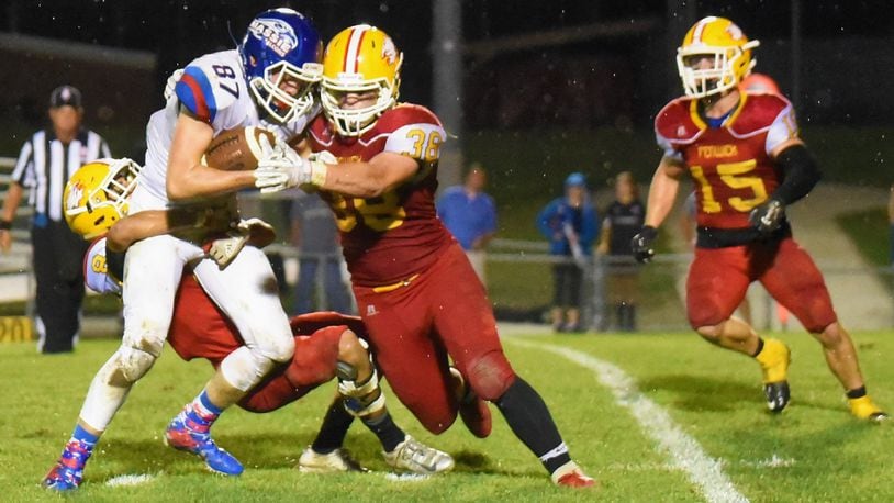 Fenwick’s Gio DiGirolamo (8), John Stevenson (38) and Henry Nenni (15) are part of a group effort in trying to bring down Clinton-Massie’s Griffin Laake (87) on Friday night at Krusling Field in Middletown. Massie took a 21-18 victory. CONTRIBUTED PHOTO BY ANGIE MOHRHAUS