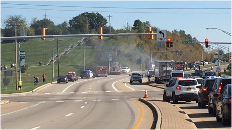 A car that caught fire at the intersection of Ohio 129 and Fair Avenue in Hamilton has traffic backed up this afternoon in both directions. The driver of that SUV has died, despite bystanders attempting to help. LAUREN PACK/STAFF