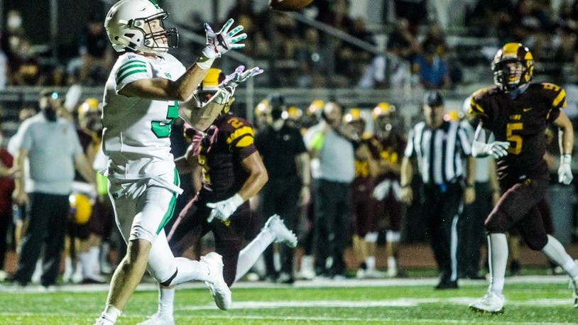 Badin's Lucas Moore makes a catch and runs it in for a touchdown during their game against Ross. Badin Rams football team defeated Ross Rams 41-7 in the first game of the season Friday, August 28, 2020 at Ross High School. NICK GRAHAM / STAFF