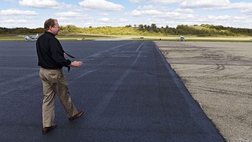 In this 2016 file photo, then-Butler County Airport Administrator Ron Davis shows off a newly paved section of asphalt during a tour of the facility. NICK GRAHAM/2016