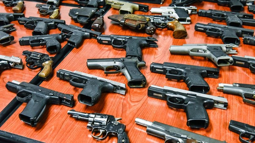 Authorities seized 116 guns of all shapes and sizes, including revolvers, semi-automatic handguns, rifles and one silencer that were displayed in February 2018 at the Butler County Sheriff's Office.  NICK GRAHAM/STAFF FILE