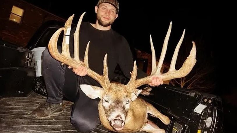 Hunter Christopher "CJ" Alexander poses with the deer he took in Clinton County. The deer's rack was green-scored at a typical 206 7/8 inches, which would push it 5 inches past the Ohio record. Photo provided by Sierra Smith.