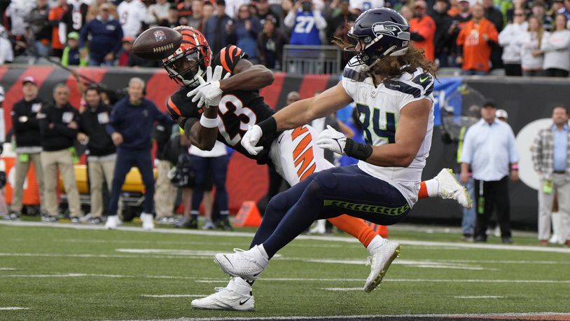 Cincinnati Bengals' Dax Hill (23) breaks up a pass intended for Seattle Seahawks' Dareke Young during the second half of an NFL football game, Sunday, Oct. 15, 2023, in Cincinnati. (AP Photo/Jeff Dean)