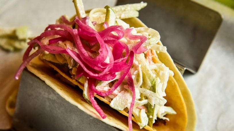 Agave & Rye features a variety of tacos and large selection of tequilas and bourbons. This is The Epic Taco with slab pork belly, apple slaw, pickled onion and rattlesnake sauce. NICK GRAHAM/STAFF