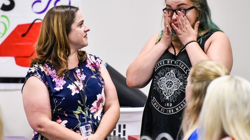 Case worker Amanda Hinkle congratulates Corina Jean on her graduation during the Butler County Children Services graduation ceremony for kids involved in the foster care program Thursday, June 21 in Hamilton. Corina graduated from Belmont High School and plans to attend Sinclair Community College to be a pharmacy tech. NICK GRAHAM/STAFF