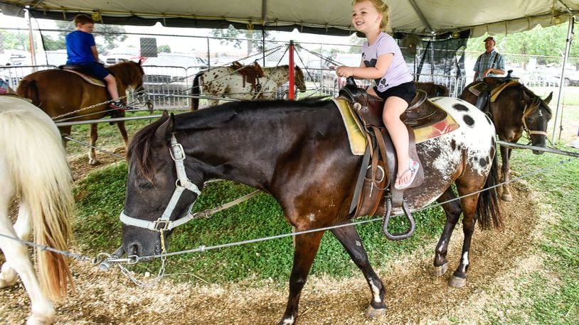 Elana Meacham, 3, rides a pony from High Winds Farm at the Butler County Fair Monday, July 23 in Hamilton. NICK GRAHAM/STAFF