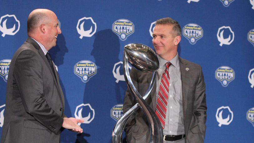 Southern California coach Clay Helton and Ohio State coach Urban Meyer pose for a photo with the Cotton Bowl trophy on Thursday, Dec. 28, 2017, at the Omni Dallas Hotel in Dallas, Texas. David Jablonski/Staff