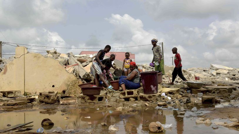 People whose houses were demolished on public health grounds collect water in the Gesco neighborhood of Abidjan, Ivory Coast, Wednesday, Feb. 28, 2024. Rapid urbanisation has led to a population boom and housing shortages in Abidjan, where nearly one in five Ivorians reside, many of them in low-income, crowded communes like the ones in the Gesco and Sebroko districts being demolished on public health grounds. (AP Photo/Diomande Ble Blonde)