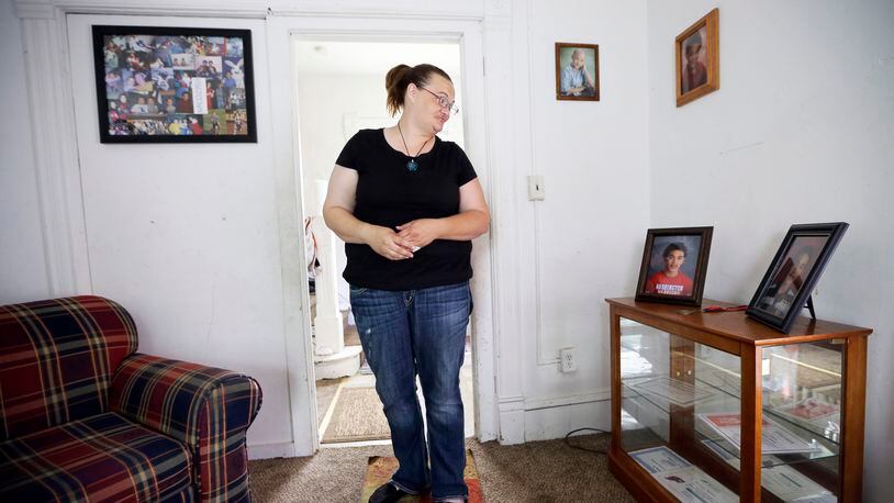 Tamara Bloemendaal looks at a photo of her son, Senquez Jackson, in Cedar Rapids, Iowa, on June 21, 2016. The 15-year old was killed earlier in the year when a gun a friend was playing with accidentally discharged. Jolted awake by her older son, she recalls helping Senquez out of the recliner and watching him collapse on the floor in a pool of blood. She rode in the ambulance with the boy she called “Chunks” as a baby. Within hours, he was dead. (AP Photo/Charlie Neibergall)