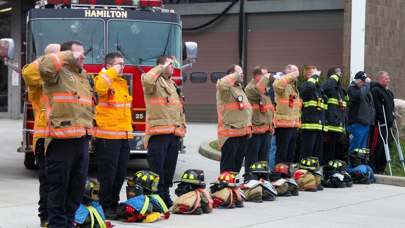 The funeral procession for Hamilton firefighter Patrick Wolterman passes by his fire station Thursday, Dec. 31. Wolterman died from injuries he sustained when he fell through the first floor of a home into the basement while battling a fire on Pater Avenue early Monday morning. GREG LYNCH/FILE