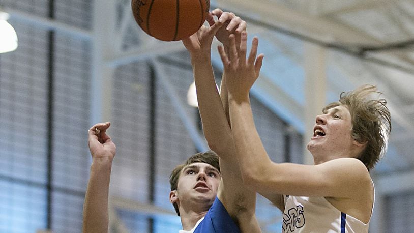 Cincinnati Christian’s Riley Reutener has his shot challenged by Middletown Christian’s Jarod Hamlin during the All-Butler County All-Star boys basketball game at the Hamilton Athletic Center in Hamilton on April 7, 2018. CONTRIBUTED PHOTO BY E.L. HUBBARD