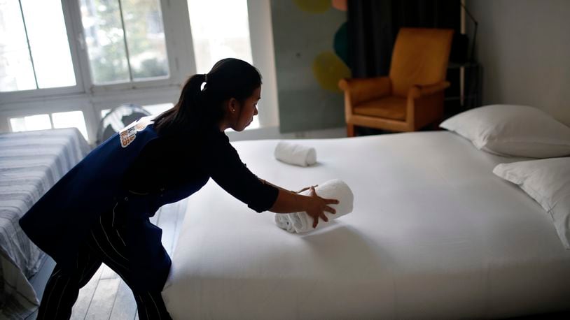 In Butler County, the only places that have begun regulating short-term rental units are Hamilton and Oxford. In this photo, a woman cleans an AirBnB rental in another region. AP FILE