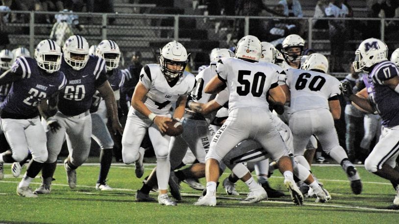Lakota East quarterback Sean Church (4) gets some blocking help from Sam Florence (50) as Middletown’s Ty Johnson (23), Javen Davis (60) and Kenny Wilson (17) are in pursuit Friday night at Barnitz Stadium in Middletown. East won 32-7. CONTRIBUTED PHOTO BY OLIVER SANDERS
