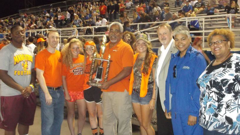 This is from the 2015 Backyard Battle when the game was last played at Xenia. Beavercreek City Councilman Brian Jarvis holds the trphy along with Beavercreek Kiwanis President Jason Hallmark, Beavercreek Rotary President Dick Gould, Xenia Mayor Marsha Bayless, Pastor Rev. Gloria Dillon of Glory Ministries Church-Xenia along with Xenia/Beavercreek student council members. CONTRIBUTED.