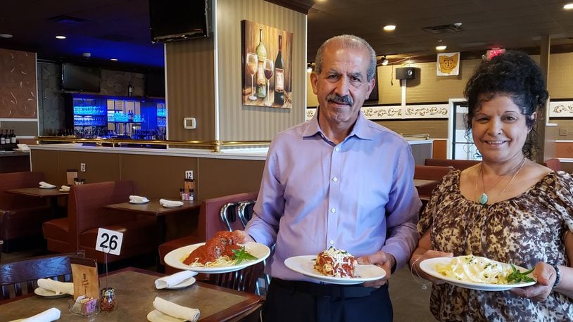 Spinning Forchetta owner George Shteiwi and his sister Laila Alghanim display Spaghetti & Meatballs, Fettuccine Alfredo and Mama Nella s Lasagna, the three most popular dishes at the Italian eatery in Liberty Twp.. Formerly known as the Spinning Fork, it relocated from Fairfield and changed its name. ERIC SCHWARTZBERG/STAFF