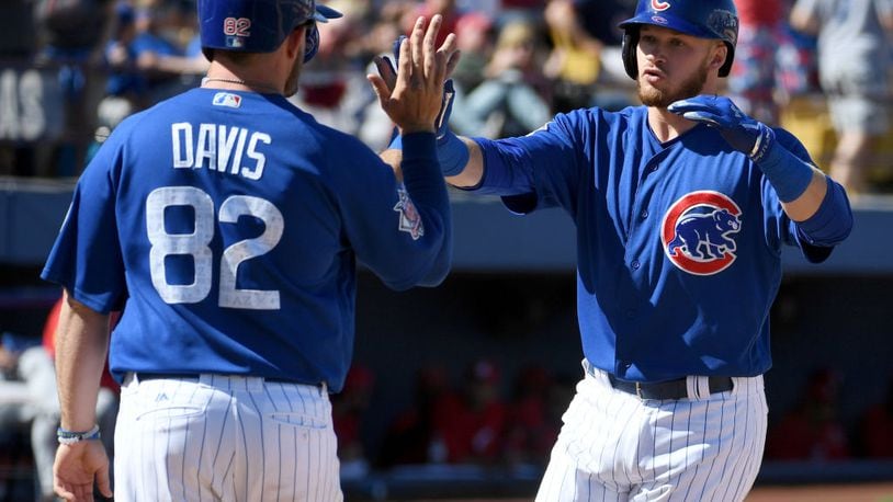LAS VEGAS, NV - MARCH 25:  Ian Happ (R) #86 of the Chicago Cubs high-fives teammates including Taylor Davis #82 after Happ hit a three-run home run in the fifth inning against the Cincinnati Reds during their exhibition game at Cashman Field on March 25, 2017 in Las Vegas, Nevada. The Cubs won 11-7.  (Photo by Ethan Miller/Getty Images)