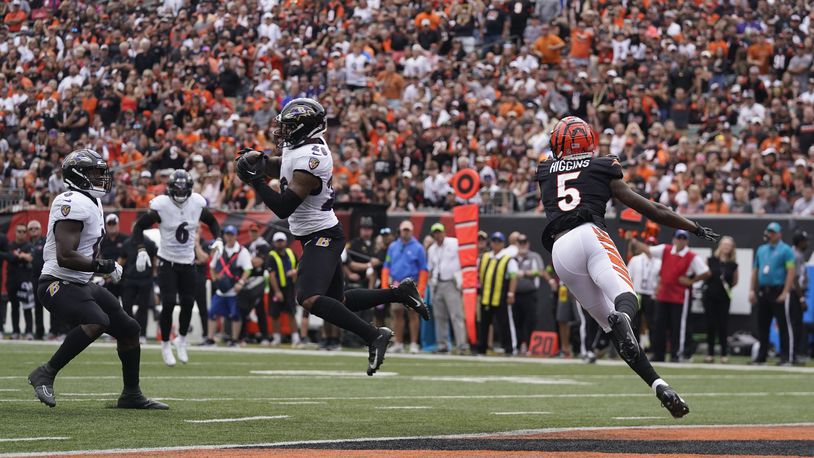 Baltimore Ravens safety Geno Stone (26) intercepts a pass intended for Cincinnati Bengals wide receiver Tee Higgins (5) during the second half of an NFL football game Sunday, Sept. 17, 2023, in Cincinnati. (AP Photo/Darron Cummings)