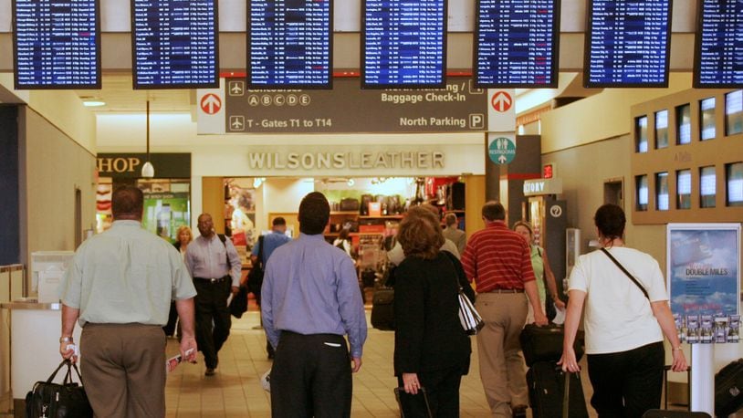 Travelers pause to check flight information before proceeding to their gates at Hartsfield-Jackson Atlanta International Airport.