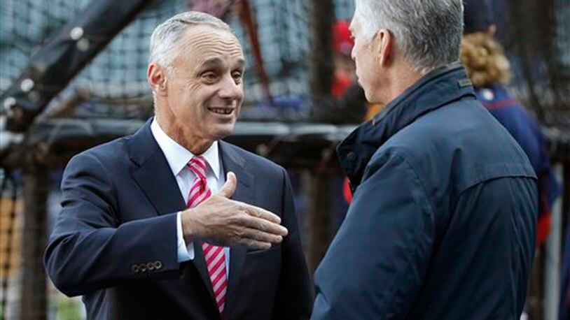 Major League Baseball commissioner Rob Manfred, left, talks with Boston Red Sox president of baseball operations Dave Dombrowski before a baseball game between the Chicago White Sox and the Red Sox Thursday, May 5, 2016, in Chicago. (AP Photo/Charles Rex Arbogast)