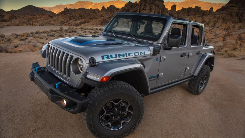 This photo provided by Fiat Chrysler shows the 2021 Jeep Wrangler Rubicon 4xe.  Fiat Chrysler on Thursday, Sept. 3, 2020, unveiled the first of what it says will be many Jeeps powered by batteries. The Jeep Wrangler 4xe is the brand's first vehicle that can travel on electricity in the U.S. The gas-electric hybrid SUV can go 25 miles on battery power before a 2-liter, four-cylinder turbocharged engine takes over. (Fiat Chrysler via AP)