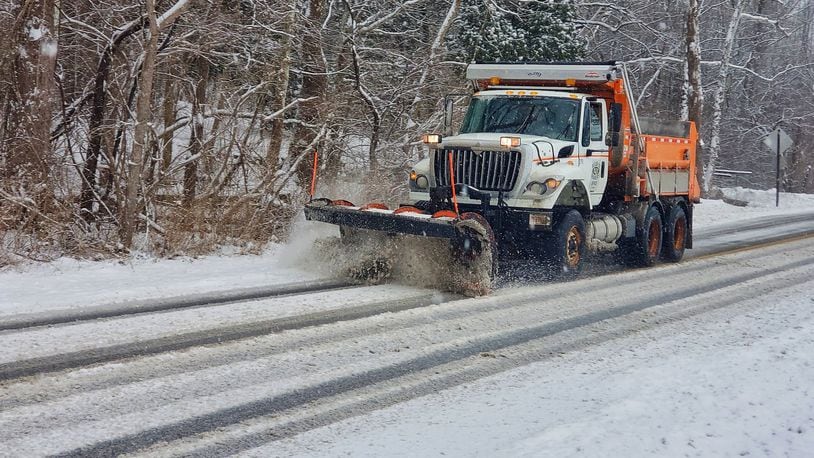 A salt truck from the Butler County Engineer’s Office plows snow from Elk Creek Road in Madison Township after snow blanketed Butler County causing slick road conditions Saturday, Jan. 12. NICK GRAHAM/STAFF