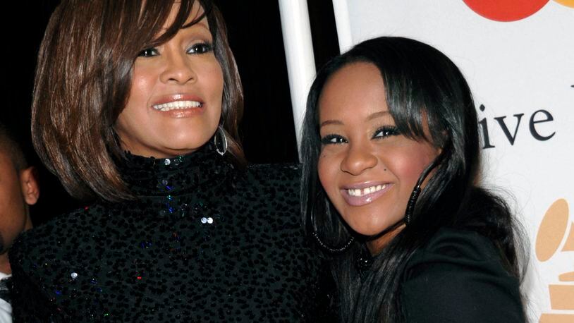 In this Feb. 12, 2011, file photo, singer Whitney Houston, left, and daughter Bobbi Kristina Brown arrive at an event in Beverly Hills, Calif. Brown, who was in hospice after months of receiving medical care, died on July 26, 2015.
