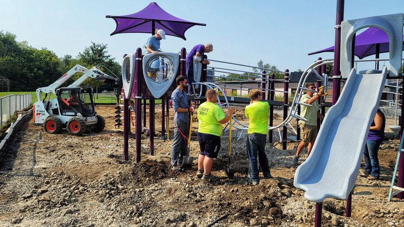 The playground at Amanda Elementary School on Oxford-State Road nears completion on Monday after four days of work from Middletown Kiwanis members and community volunteers. NICK GRAHAM/STAFF