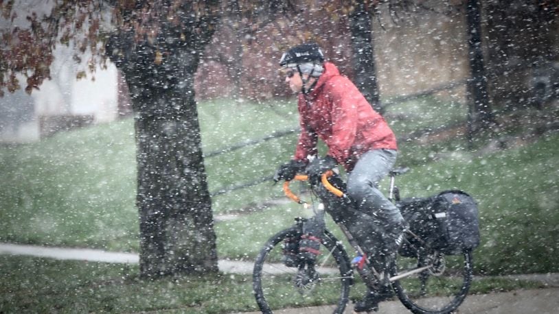 The snow didn't seem to slow down this bicyclist riding along Main Street in Xenia Monday, Nov. 30, 2020. MARSHALL GORBY\STAFF