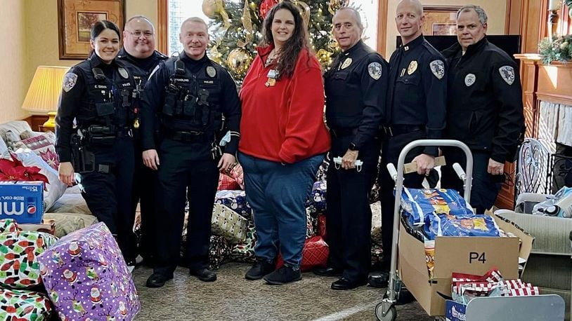 The Fairfield Twp. Police Department purchased gifts for the 64 residents at Birchwood Care Center, a nursing facility in the township. From left are Detective Emma Edens, Sgt. John VandeRyt, Detective Nic Spalding, Walmart's Rachel Hucks, Chief Robert Chabali, Capt. Doug Lanier, and School Resource Officer Jeffrey McDaniel.