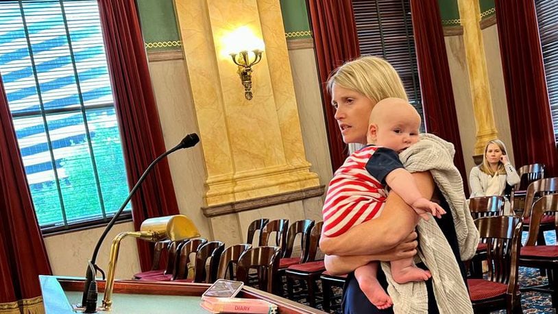 Erin Merryn testified Tuesday before the Ohio Senate Primary and Secondary Education Committee. She is holding her three-month-old son, Jack. On the podium is a pink childhood diary where she wrote about being sexually abused, because she was afraid to tell any safe adults. Laura Hancock/cleveland.com