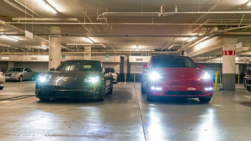 This photo provided by Edmunds shows a 2020 Porsche Taycan and 2020 Tesla Model Y Performance at the beginning of a daylong range and consumption test. The results would eventually show the Taycan outperforming its EPA range estimates by nearly 60%, while the Tesla Model Y was pretty spot-on with its EPA figures. (Rex Tokeshi-Torres/Edmunds via AP)