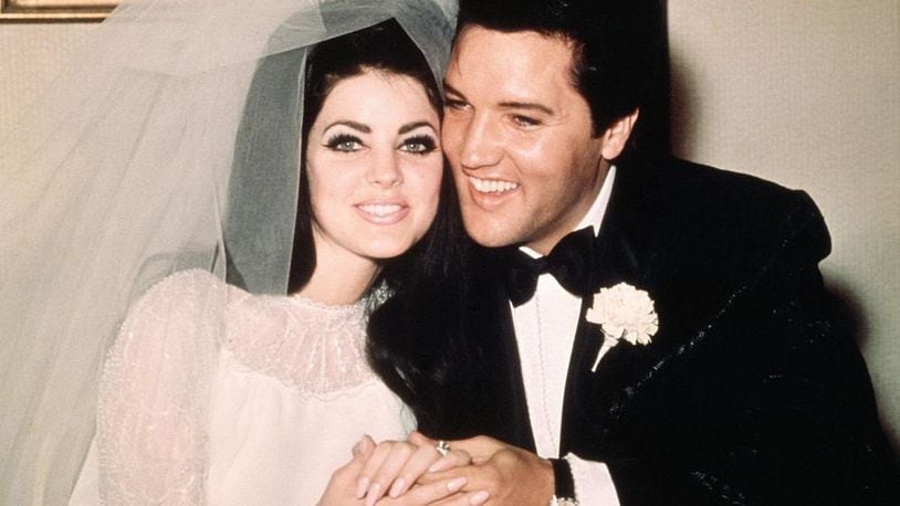 Elvis Presley sits cheek to cheek with his bride, the former Priscilla Ann Beaulieu, following their wedding May 1, 1967.
