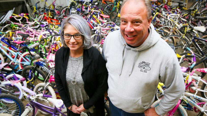 Jamie Beringer and Dave Lodder of Bicycle Recycle are looking to donate 200 bicycles to area children via local organizations, but first they want to raise enough money to purchase safety helmets to go along with each bicycle. GREG LYNCH / STAFF