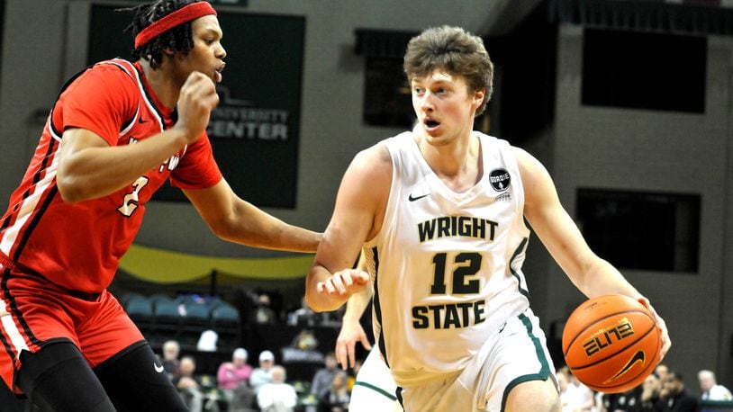 Wright State's AJ Braun, 12, drives past Youngstown States Malek Green, 2, during the first half of a Horizon Conference game at the Nutter Center on Sunday, Dec. 4. DAVID A. MOODIE/CONTRIBUTING PHOTOGRAPHER