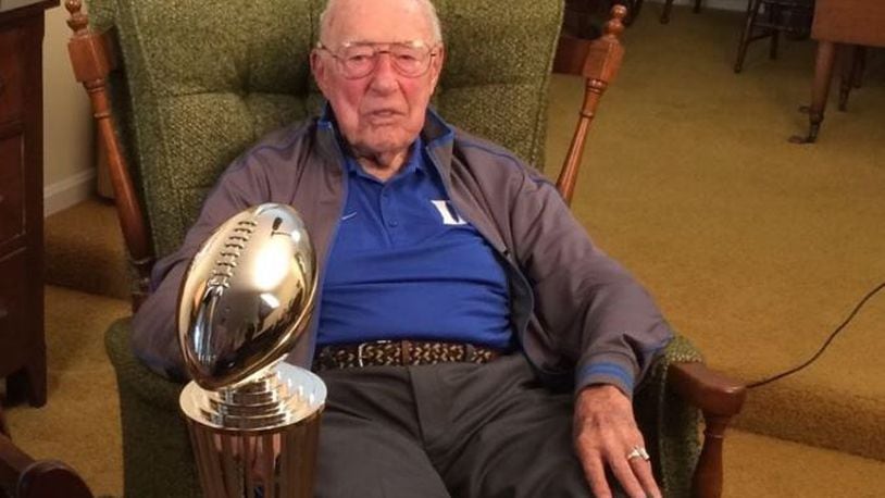 Jim Smith, 95, of Hamilton, is the last living football player who played in the 1942 Rose Bowl game when Oregon State upset Duke. Smith is pictured in his Louisville home with the 2017 Rose Bowl trophy.