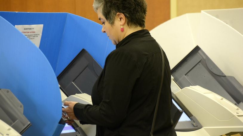 Early voting started in Ohio on Wednesday, Oct. 10. Butler County saw more than 600 people vote on the first day of early voting. Pictured is a voter casting an early ballot Wednesday morning at the Butler County Board of Elections. MICHAEL D. PITMAN/STAFF