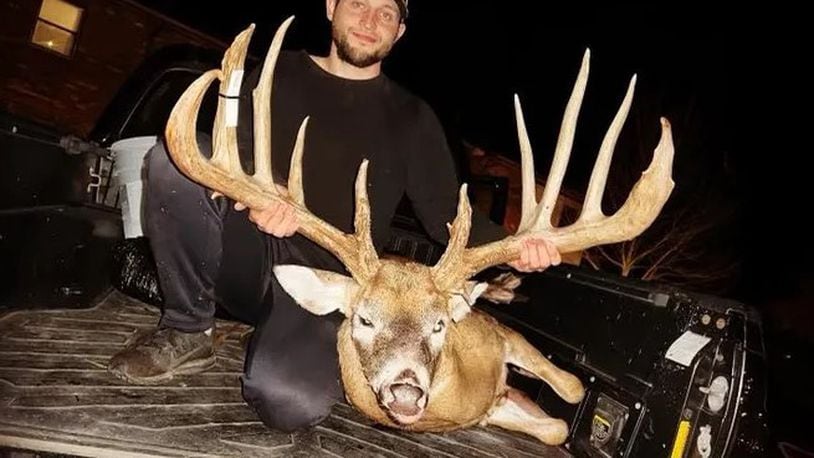 Hunter Christopher "CJ" Alexander poses with the deer he took in Clinton County. The deer's rack was green-scored at a typical 206 7/8 inches, which would push it 5 inches past the Ohio record. Photo provided by Sierra Smith.
