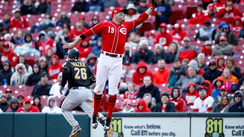 CINCINNATI, OH - MARCH 31: Adam Frazier #26 of the Pittsburgh Pirates reaches first base ahead of the throw to Joey Votto #19 of the Cincinnati Reds for an infield single in the eighth inning at Great American Ball Park on March 31, 2019 in Cincinnati, Ohio. The Pirates won 5-0. (Photo by Joe Robbins/Getty Images)