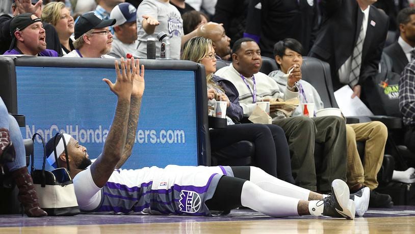 Sacramento Kings center DeMarcus Cousins lies on the sideline and looks to be waiting for a foul call against the New Orleans Pelicans during the second half of an NBA basketball game in Sacramento, Calif., Sunday, Feb. 12, 2017. The Kings won 105-99. (AP Photo/Steve Yeater)