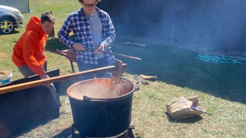 Volunteers help with a live demonstration of apple butter kettle cooking at the 57th Apple Butter Festival Oct. 2, 2022 at the Doty Homestead at Hueston Woods State Park. TAJ SIMMONS/CONTRIBUTED