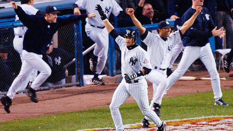 FILE - In this Oct. 16, 2003, file photo, New York Yankees' Aaron Boone, center, celebrates after hitting a solo home run in the 11th inning to beat the Boston Red Sox in Game 7 of the American League Championship Series in New York. Boone became the first person with no experience as a manager of coach to interview to become Joe Girardi's successor with the New York Yankees. The 44-year-old interviewed Friday, Nov. 17, 2017, becoming the fourth to go through the process after Yankees bench coach Rob Thomson, former Cleveland and Seattle manager Eric Wedge, and San Francisco bench coach Hensley Meulens. (AP Photo/Bill Kostroun, File) ORG XMIT: NY184