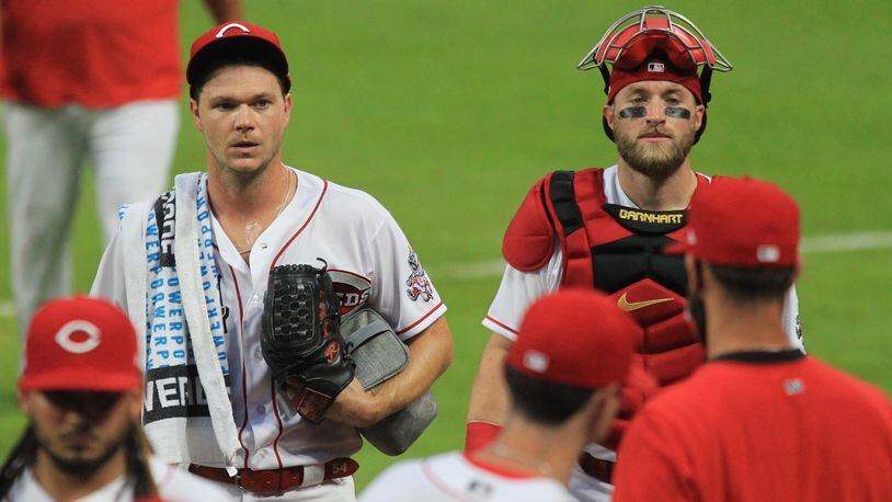Reds pitcher Sonny Gray and catcher Tucker Barnhart return to the dugout after warming up before a game against the Indians on Monday, Aug. 3, 2020, at Great American Ball Park in Cincinnati.