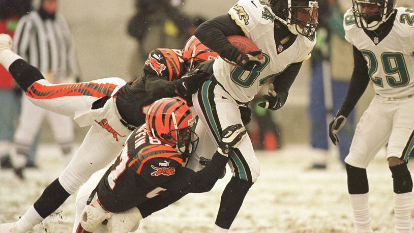 17 Dec 2000: Jacksonville Jaguar Reggie Barlow #84 is tackled Cincinnati Bengals Damon Griffin #87 and Ron Dugans #81 while returning a punt during their game at Paul Brown Stadium in Cincinnati, Ohio. The Bengals won the game 17-14 on a Neil Rackers 27-yard field goal as time expired. Mandatory Credit: Jonathan Daniel/ALLSPORT