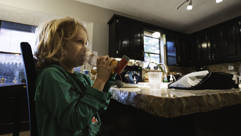File - Lachlan Rutledge, 6, during his morning routine which involves time with the inhaler after breakfast while preparing for school, in Broken Arrow, Okla. on Oct. 3, 2022. Liquid albuterol for nebulizers continues to be in short supply in March 2023, but a spacer device can be used with an inhaler that is just as effective as a nebulizer, doctors say. (Melissa Lukenbaugh/The New York Times)